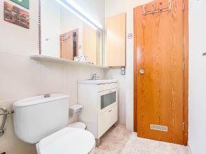 a small bathroom with a toilet and a sink at Bungalow Chill Terrace in Maspalomas & Pool in San Bartolomé de Tirajana