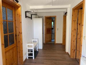 a hallway with wooden floors and wooden doors at Lodge am Wald Terrasse Garten Grill ruhige Lage Wandern in Wienrode