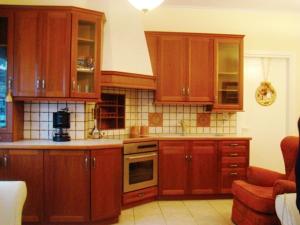 a kitchen with wooden cabinets and a stove top oven at Litochoro Apartments in Litochoro