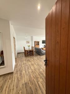 an open door to a living room with a table at Casa De la Vega in Cenes de la Vega