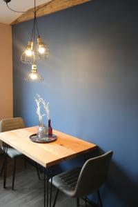 a dining room table with two chairs and two lights at BLUMENSTIL Ferienwohnungen 3 in Bad Salzungen +2 photos