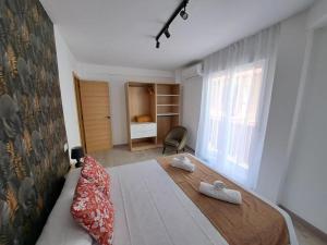 a bedroom with a bed with two towels on it at Chloe Apartments TRG in Benidorm