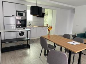 a kitchen and dining room with a table and chairs at Chloe Apartments TRG in Benidorm