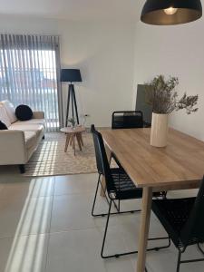 un soggiorno con un tavolo e un divano di AG APARTMENTS Trelew a Trelew Altre 3 foto