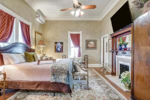 a bedroom with a bed and a fireplace at The Gallery House Boutique Hotel in Stephenville