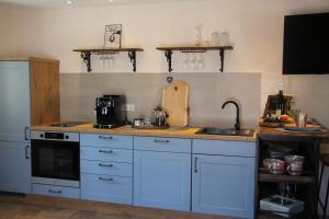 a kitchen with white cabinets and a counter top at Casa No7- piano terra in Naumburg