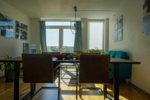 a dining room with a table and chairs and a window at Solrik leilighet på Byåsen in Trondheim