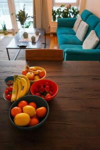 two bowls of fruit on a wooden table in a living room at Solrik leilighet på Byåsen in Trondheim +3 photos
