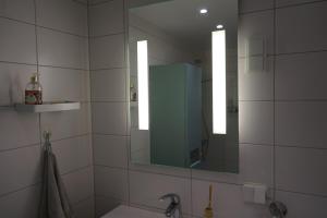 a bathroom with a sink and a mirror at Solrik leilighet på Byåsen in Trondheim