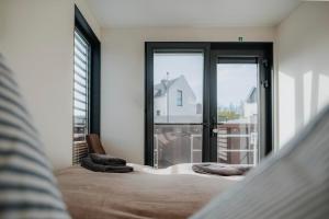 a bedroom with a bed and a large window at Hausboot Trinity - LP5 in Peenemünde