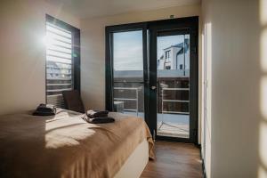 a bedroom with a bed and a large window at Hausboot Trinity - LP5 in Peenemünde