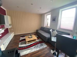 a living room with a couch and a table at Alte Molkerei FeWo 1 in Zilly