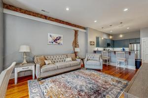 a living room with a couch and a kitchen at Eagle Claw Den in Waynesville