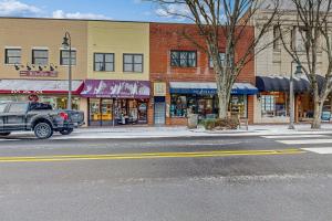 a truck parked on a street in front of stores at Eagle Claw Den in Waynesville