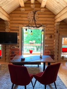 a dining room with a table and chairs and a window at Hahnenkleer Hütte Harzliebe in Goslar +16 photos