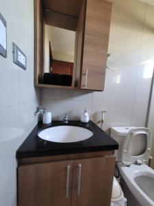 a bathroom with a sink and a toilet at Departamento céntrico solo para ti in Santa Cruz de la Sierra