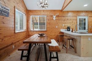 a kitchen with wooden walls and a wooden table at Basecamp in La Pine +26 photos