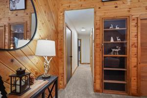 a hallway in a log cabin with a mirror at Basecamp in La Pine