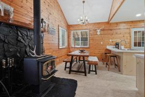 a living room with a stove in a kitchen at Basecamp in La Pine