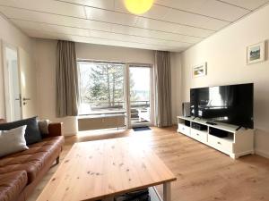 a living room with a couch and a flat screen tv at Hahnenkleer Tied 1 in Hahnenklee-Bockswiese