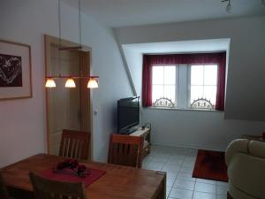a living room with a table and a television at Ferienwohnung Böcker in Oberwiesenthal