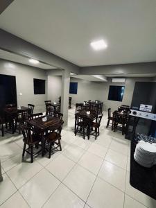a dining room with wooden tables and chairs at Pousada Caribe Brasileiro in Maragogi