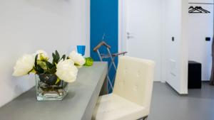 a vase filled with white flowers sitting on a table at New Dimora Valmar in Polignano a Mare