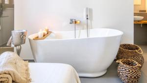 a white bath tub in a bathroom with candles at New Dimora Valmar in Polignano a Mare