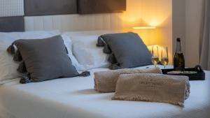 a white bed with two pillows on top of it at New Dimora Valmar in Polignano a Mare