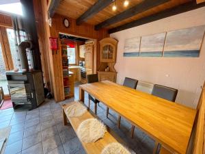 a dining room with a table and a stove at Ferienhaus Sinja in Extertal