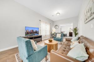 a living room with a couch and a tv at Cozy Buffalo Getaway Minutes to Downtown & Bills Stadium in Buffalo