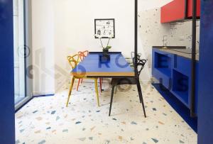 a table in a kitchen with a blue cabinet at GALAXY By ROMEI in Rome