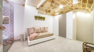 a couch sitting in a room with a wall at New Dimora Valmar in Polignano a Mare