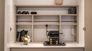 a shelf in a kitchen with a coffee maker at New Dimora Valmar in Polignano a Mare