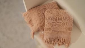 a brown knitted sweater hanging on a wall at New Dimora Valmar in Polignano a Mare