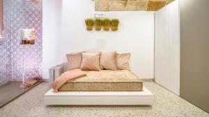 a bedroom with a bed with pink pillows on it at New Dimora Valmar in Polignano a Mare