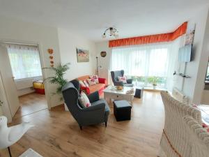 a living room with a couch and a table at Ferienwohnung Mohnblume in Sassnitz +5 photos