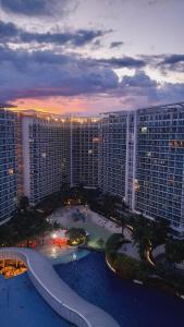 an aerial view of a large building at sunset at The Bahamas & Maldives Suites at Azure Residences near Manila Airport in Manila