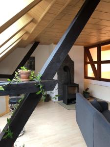 a living room with a couch and a wood stove at Lissy's alte Schmiede in Großwechsungen