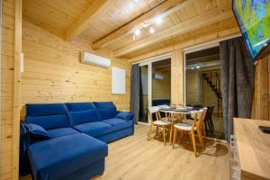 a living room with a blue couch and a table at Domek Jelonek Rykowisko in Korbielów