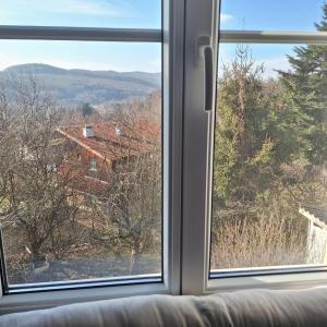 a window with a view of a house at Apartment in country house in Pressbaum