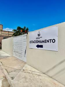 a sign on the side of a building with a sashotamite sign at Pousada Caribe Brasileiro in Maragogi