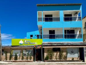 a blue building with a yellow sign on it at Pousada Caribe Brasileiro in Maragogi +32 photos