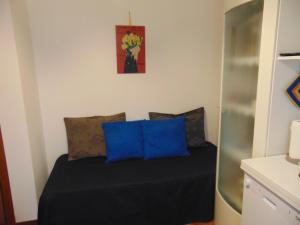 a bed with blue pillows in a room at Podere Luma Camera Roseto - Mimosa in Gambassi Terme