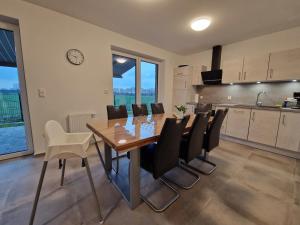a kitchen and dining room with a wooden table and chairs at Haus Ems in Haselünne