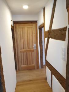 einen Flur mit Holztür in einem Zimmer in der Unterkunft Torhaus Rattelsdorf - Wohnung 2 Edelweiß in Rattelsdorf