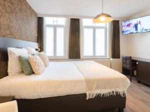 Postel nebo postele na pokoji v ubytování Hotel Kristoffel - Ontbijt inbegrepen