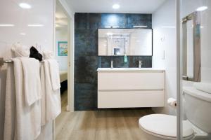 a white bathroom with a sink and a toilet at La Vista Resort in Simpson Bay
