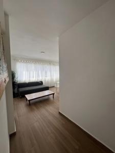 a living room with a couch and a coffee table at punta cana bavaro apartamentos beach club los corales in Punta Cana