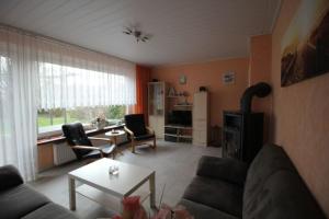 a living room with a couch and a table at Ferienhaus Brigitte in Dornum